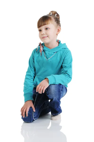 Charming little girl seated in a model pose. Isolated on the whi — Stock Photo, Image