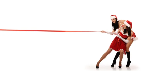 Girls pull red ribbon — Stock Photo, Image