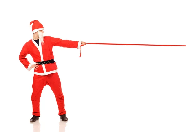 Санта-Клаус держит красную ленточку — стоковое фото