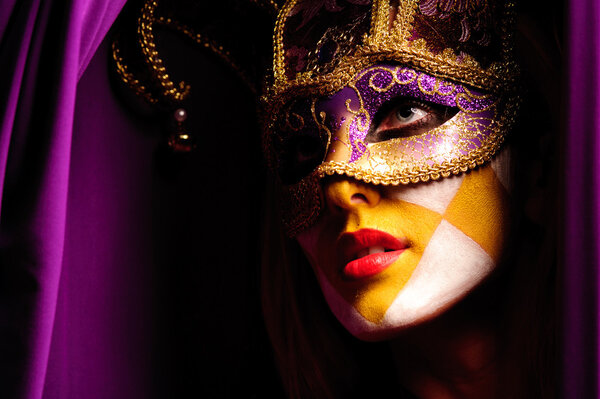 Close up portrait of sexy woman in violet party mask