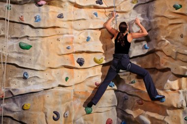 Woman on rock wall clipart