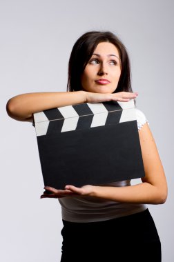 Young woman holding a clapper clipart