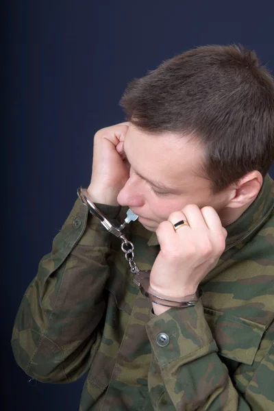 stock image The man tries to remove handcuffs from hands