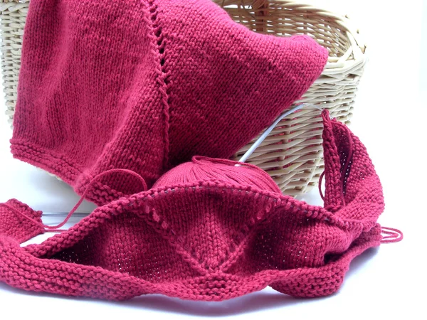 Red knitting with whole pattern in a wooden basket — Stock Photo, Image