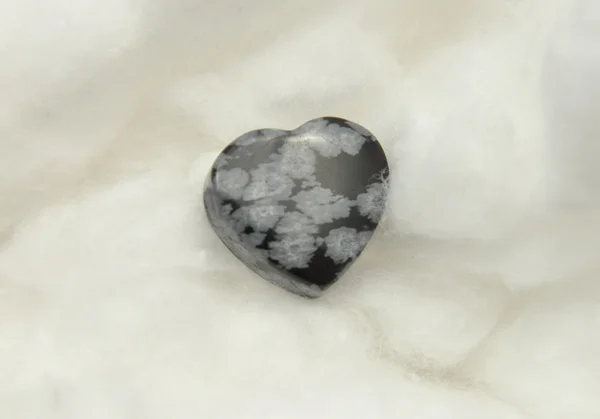 Snowflake obsidian on cotton — Stock Photo, Image