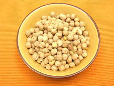 One bowl of ceramic with garbanzos on orange clipart