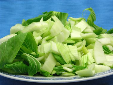 Pak choi cutted on a blue background clipart