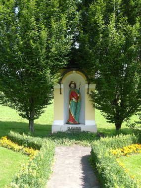 Holy statue as place for praying for christians in Freiland Austria clipart