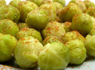 Seasoned brussels sprouts arranged on a plate clipart