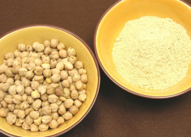 Two bowls of ceramic with garbanzos and flour of garbanzos clipart