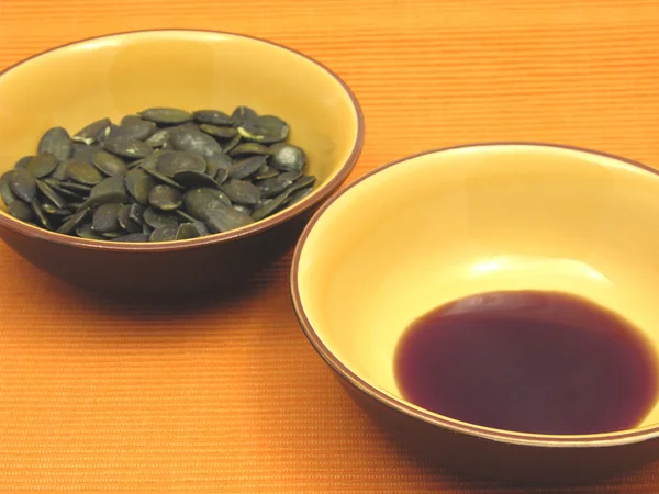 stock image Two bowls of ceramic with pumpkin seeds and pumpkin seed oil