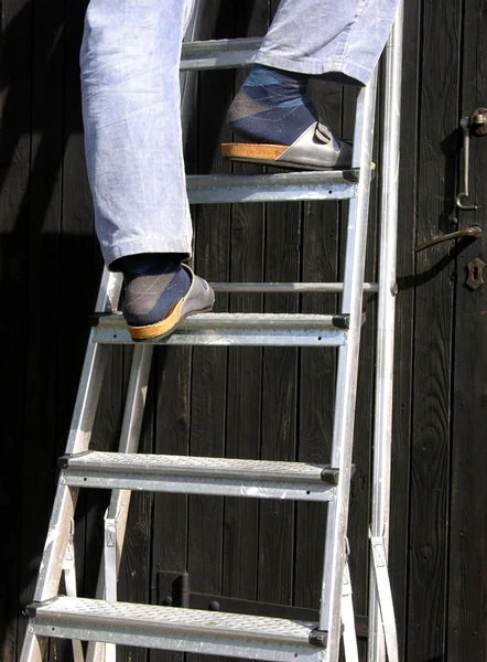 stock image Cutout man is climbing a ladder on wooden door