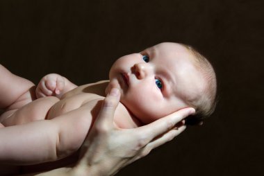 Child in mother's hands clipart