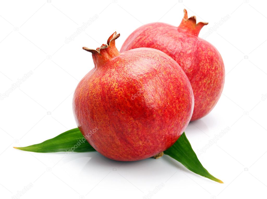 Pomegranate fruits with green leaf isolated