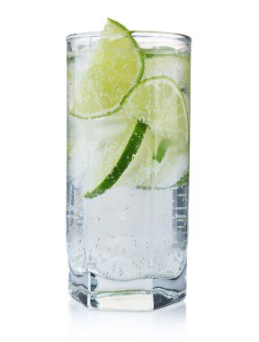 Full glass of fresh cool tonic with lime fruits isolated clipart