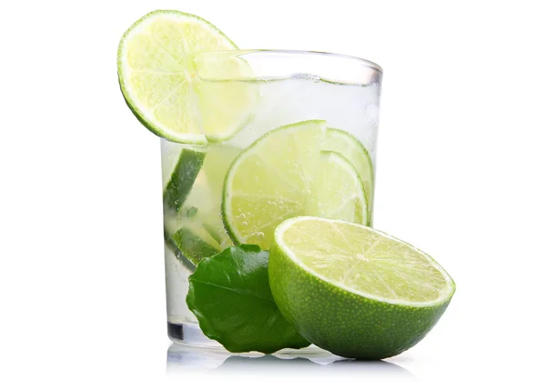 Full glass of fresh cool tonic with lime fruits isolated Royalty Free Stock Images