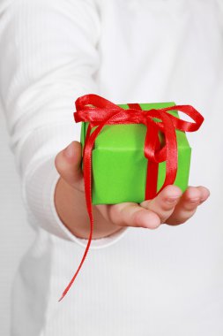 Child holding a present clipart