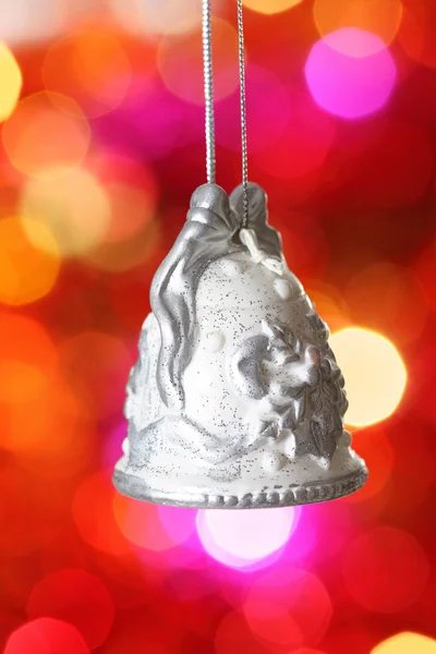 Christmas bell with silver pattern against blurred background — Stock Photo, Image