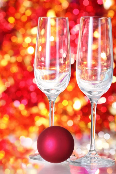 Two empty glasses and red ball decoration — Stock Photo, Image