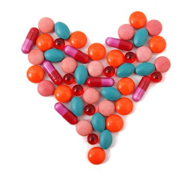 Heart from milticolor pills on white background clipart