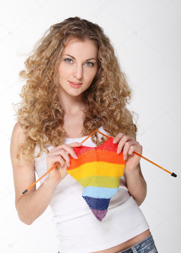 Beautiful blond girl with multicolor knitted heart
