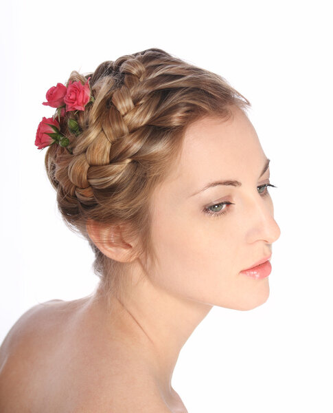 Portrait of the beauty young blond girl with roses in her hair