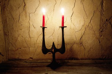 Candlestick on dark background clipart