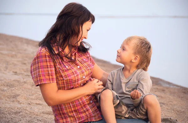 stock image The mother and the son have a rest on seacoast