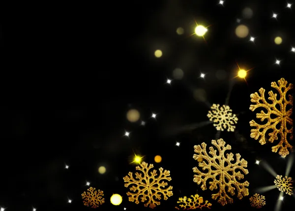 Kerstmis achtergrond - gouden sneeuwvlokken op een zwart — Stockfoto