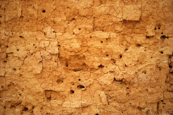 Abstrakt bakgrund i form av spruckna lera väggen — Stockfoto
