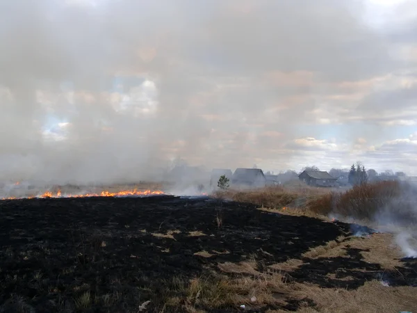 stock image Grassland Fire approaches on village, there can be a fire