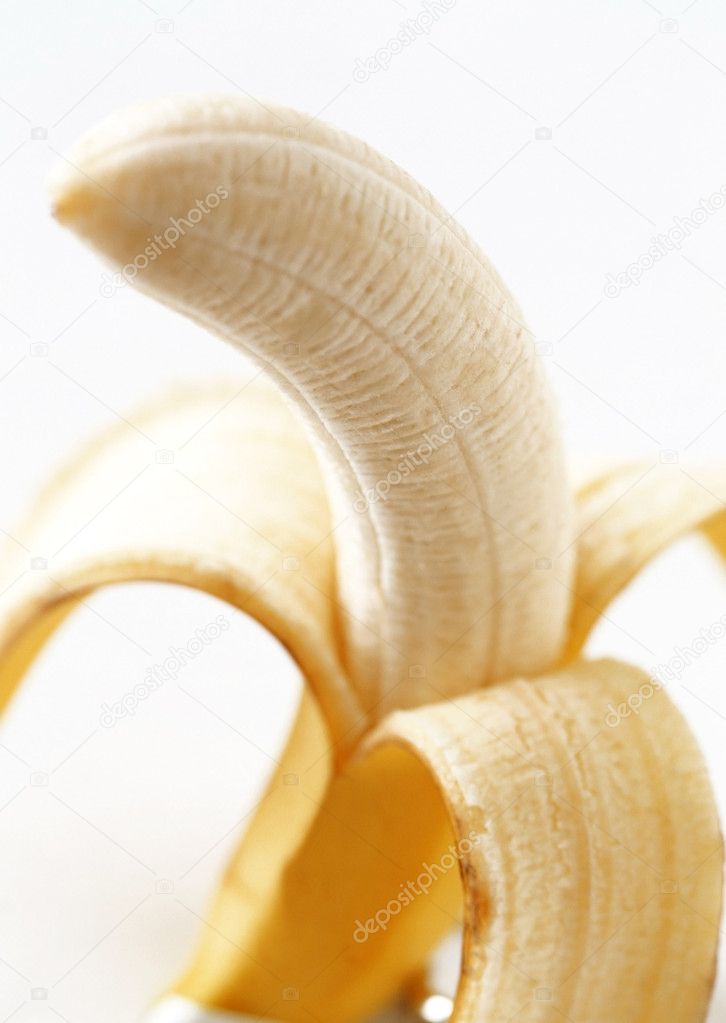 Peeled banana on a white background