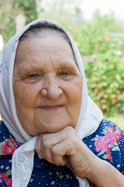 Portrait of the old woman in a scarf — Stock Photo, Image
