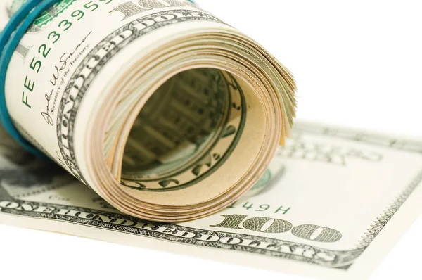 Rotolo di denaro e arco isolato su sfondo bianco — Foto Stock