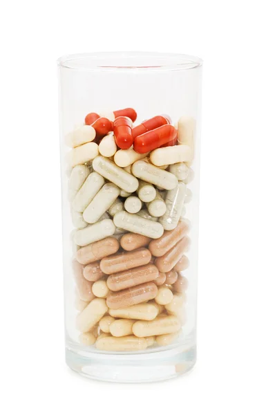 Pillole in un bicchiere isolato su sfondo bianco — Foto Stock