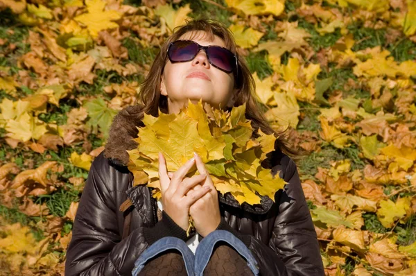 Το όμορφο κορίτσι με το φθινόπωρο τα φύλλα — Stockfoto