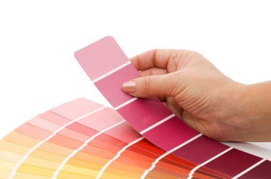 Woman hand pointing to a sample color chart