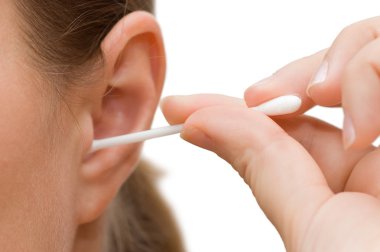 A woman cleaning her ear with cotton swab clipart