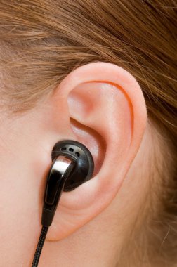 Ear-phone in a female ear clipart