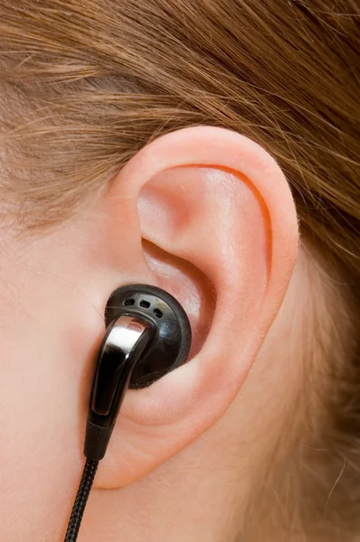 Ucho telefon v ženské ucho — Stock fotografie