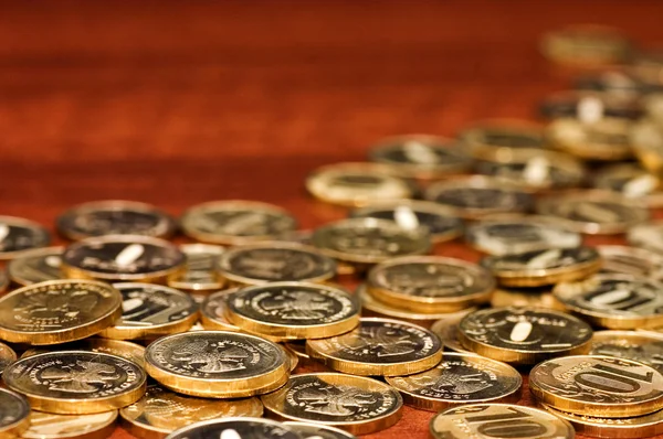 Golden coins on a wooden table — Stock Photo, Image