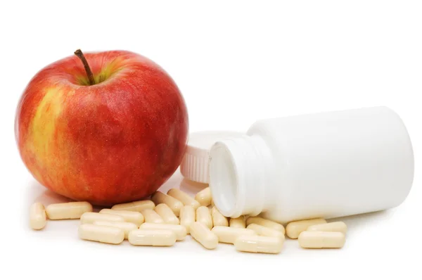 Äpple med piller isolerad på vit bakgrund — Stockfoto