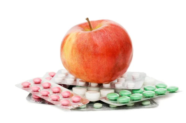 Manzana con pastillas aisladas sobre fondo blanco —  Fotos de Stock
