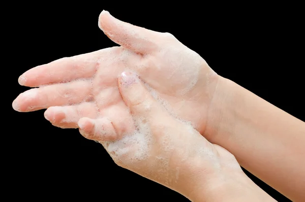 Female hands in soapsuds isolated on black — Stock Photo, Image
