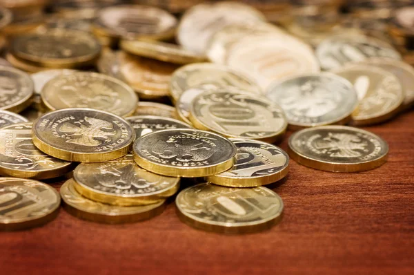 Gouden munten op een houten tafel — Stockfoto