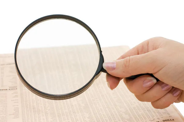 Magnifying glass in hand and text - business background — Stock Photo, Image