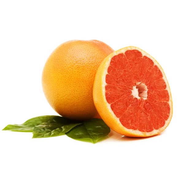 Fresh juicy grapefruits with green leafs — Stock Photo, Image