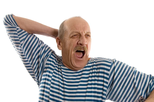 Oudere man in een gestripte vest gaapt — Stockfoto