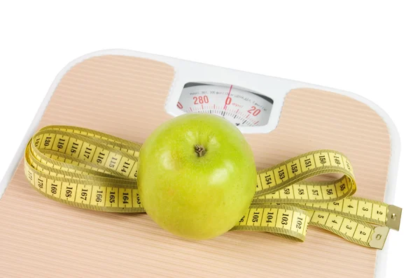 Scale, tape and apple on white background — Stock Photo, Image