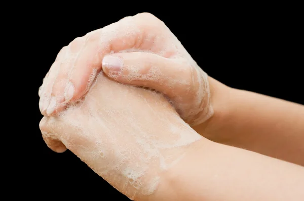 Женские руки в мыле на черном фоне — стоковое фото